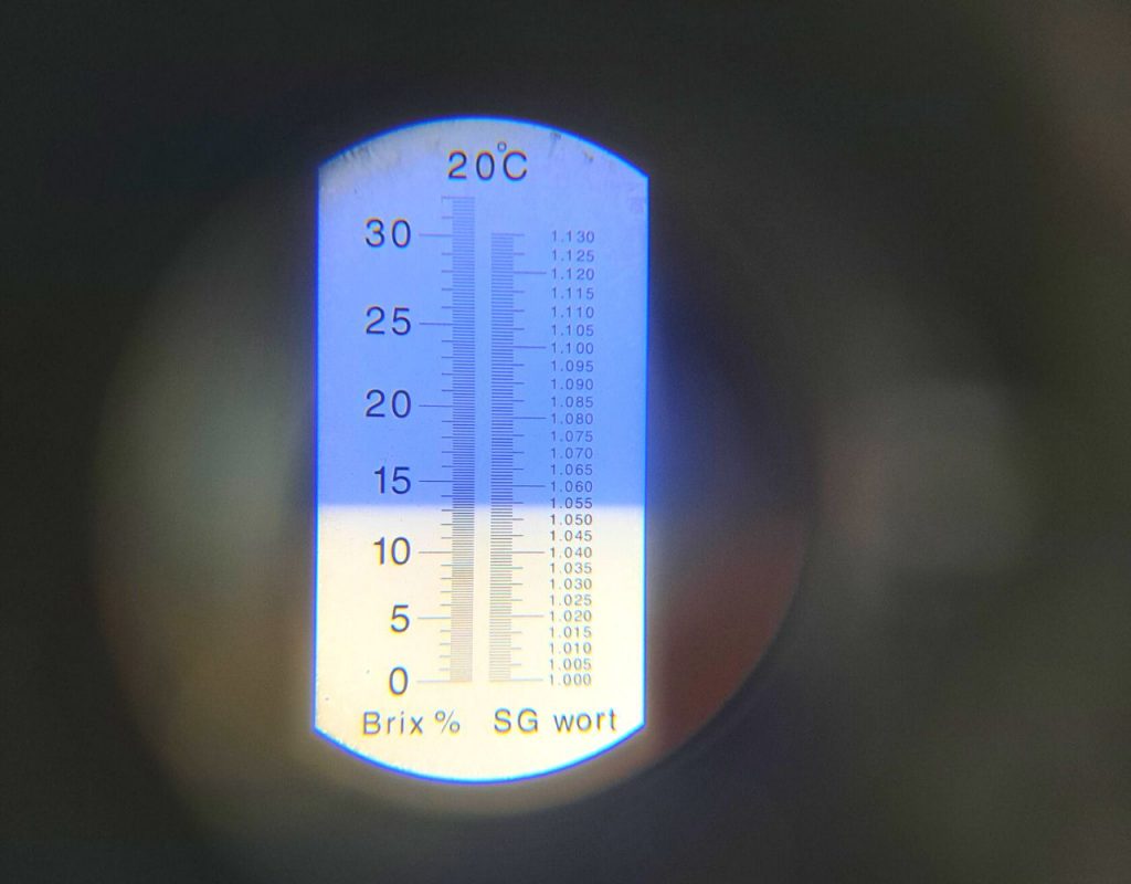 Image of DIY Distilling Checking the original gravity of the whiskey wash using a refractometer