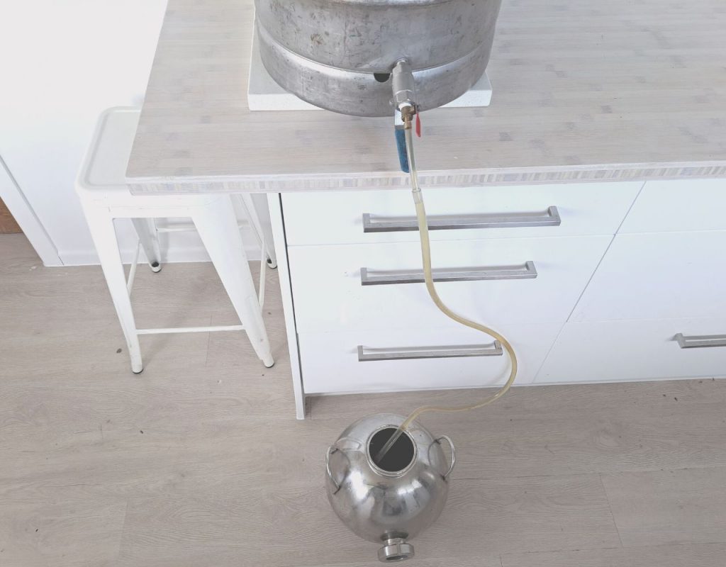 Image of DIY Distilling racking off whiskey wash into boiler