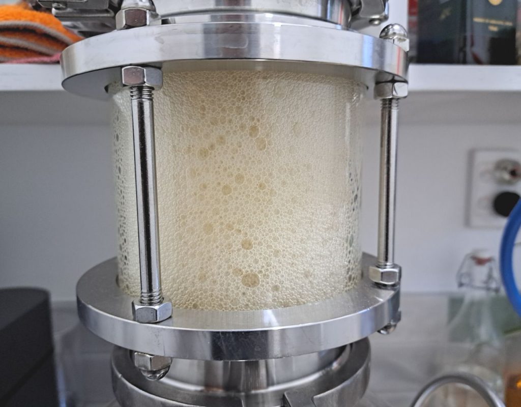 Image of DIY Distilling Sightglass in distillation column showing that still is puking or boiling over