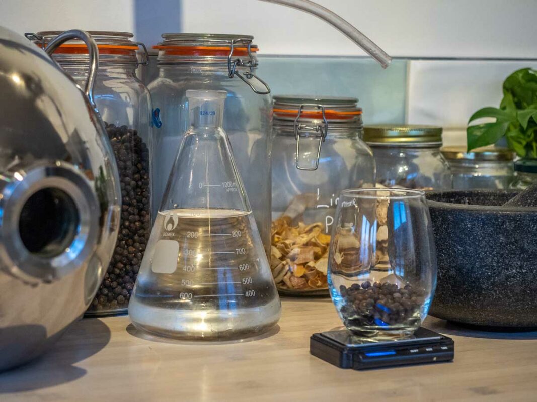 Image of DIY Distilling weighing juniper berries and neutral spirit to make gin