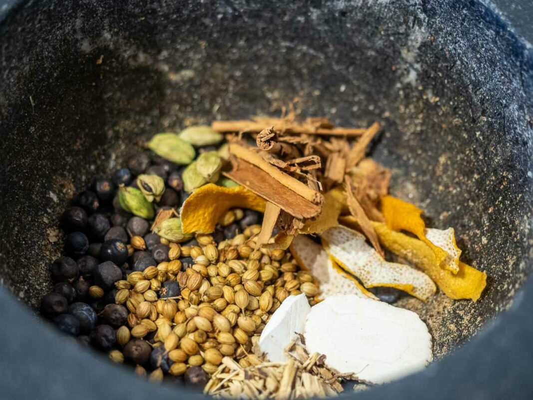 Old Tom Gin Recipe (Sweetened Gin!) 3 Image of DIY Distilling crushing gin botanicals for making old tom gin recipe